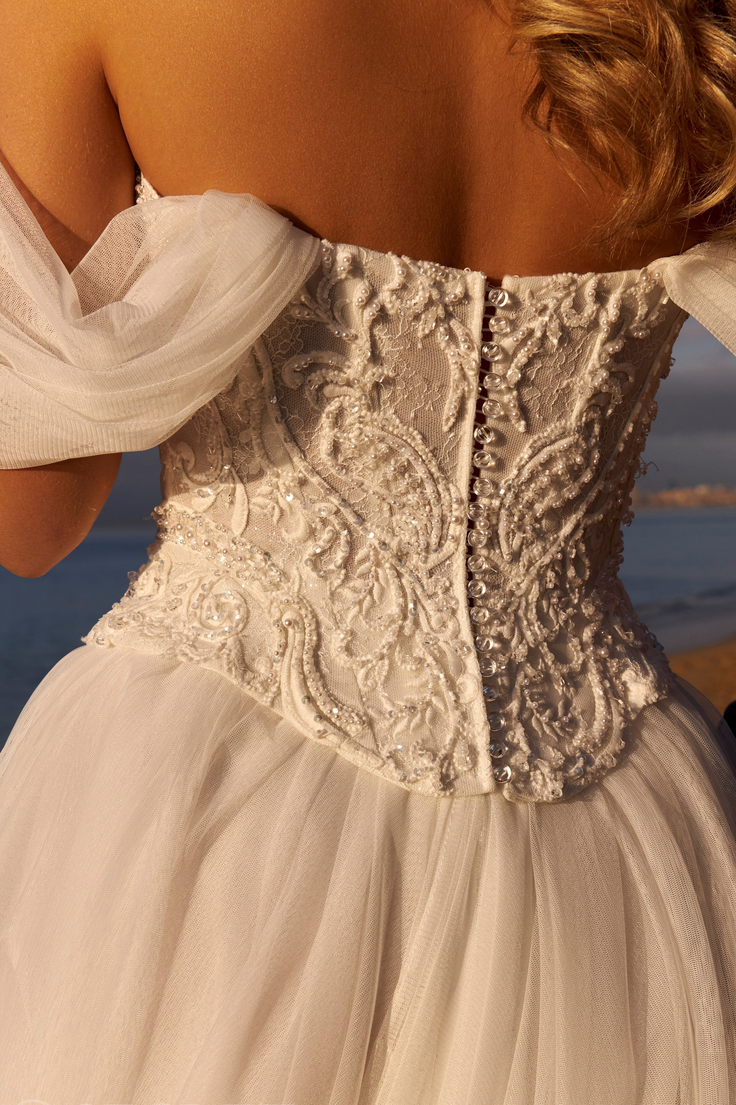 Close-up of a detailed lace bodice of a wedding dress with a blurred background